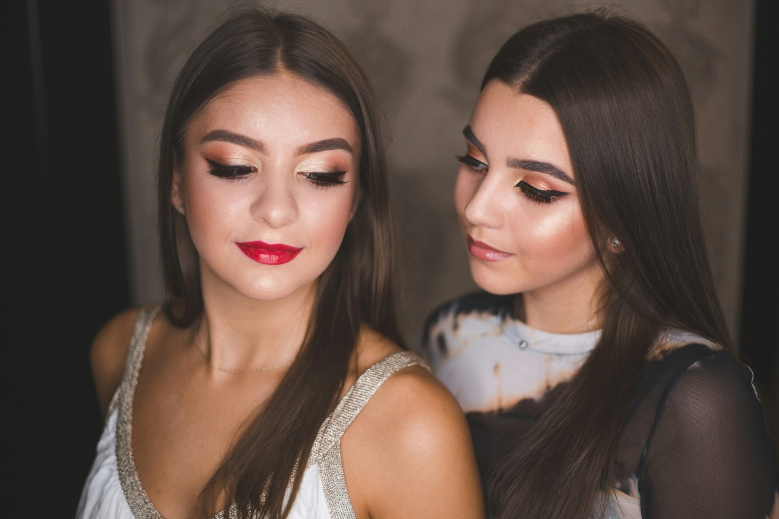 two beautiful young women standing next to each other